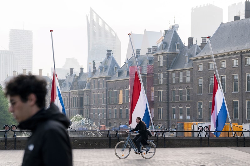 Dutch flags hang at half-mast at the Hofvijver for Remembrance Day.