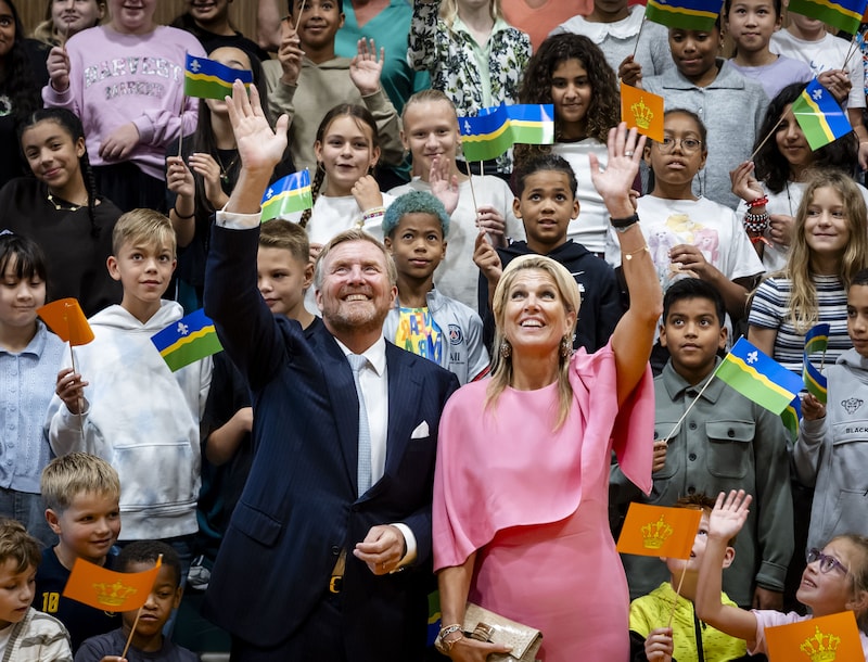 Het koningspaar gaat op de foto met kinderen in buurtcentrum De Ruimte.