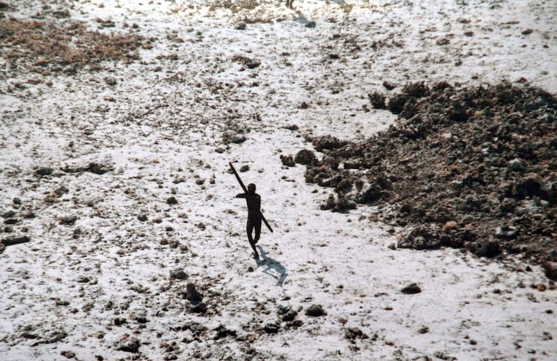 Photo from 2004, one of the rare images showing residents of North Sentinel Island. The man aims a bow and arrow at a helicopter. 