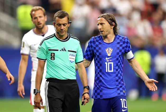 Luka Modric complains to Clement Turpin after the penalty early in the match.